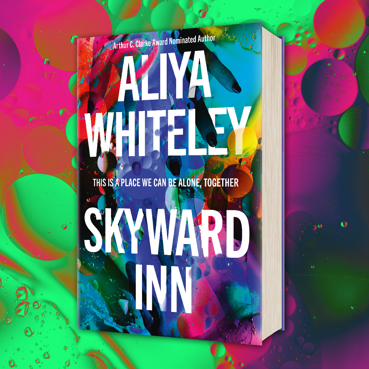 Hardback edition of Skyward Inn by Aliya Whiteley on a colourful background